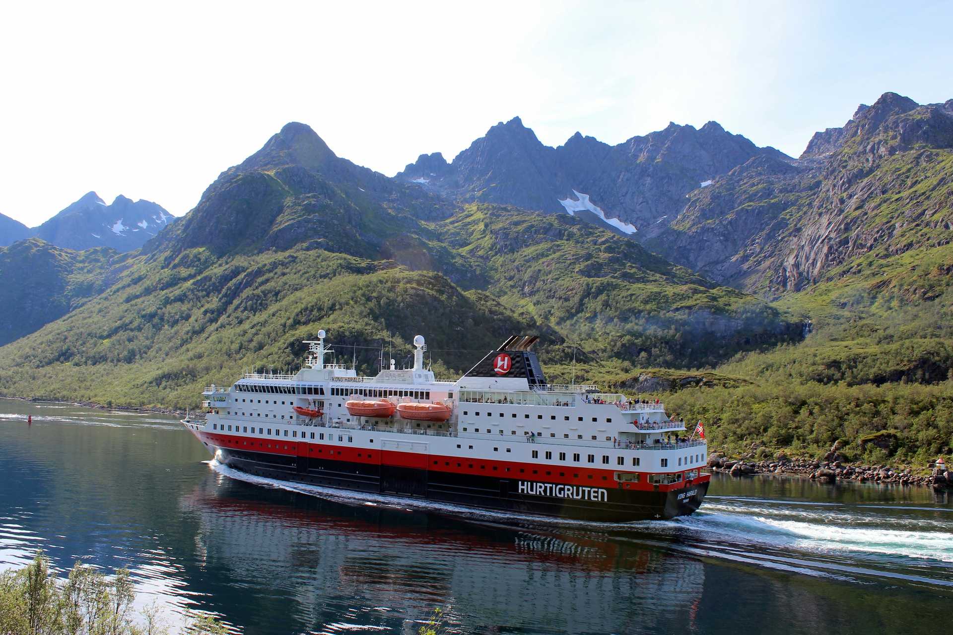 white cruise ship near mountains